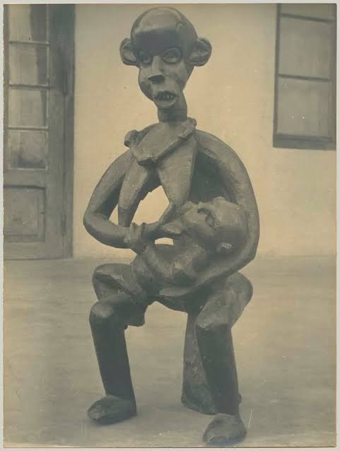 Maternity figure, Grassfields (Cameroon): a seated mother nursing her child, carved wood